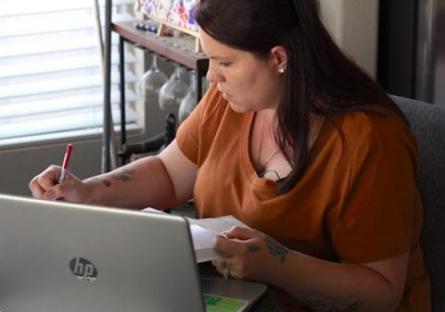 photo of Rio Salado College student Brittany Gray studying with a laptop and notebook