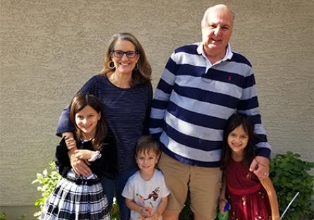 photo of Gina Pinch with her husband and three grandchildren