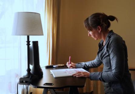 Picture of Meredith Jaxon writing at a desk