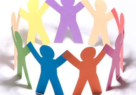 A circle of multi-colored paper dolls holding hands