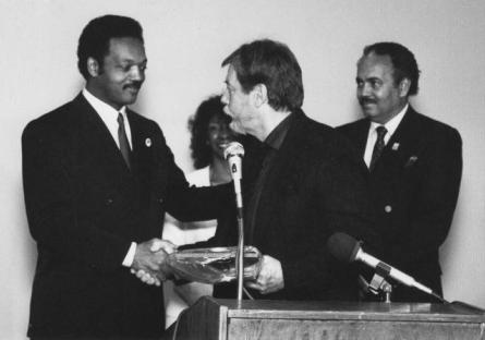 black and white photo of Jean Tease with Rev. Jesse Jackson and Chancellor Paul Elsner