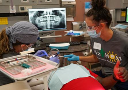 image of dental students working on a patient.