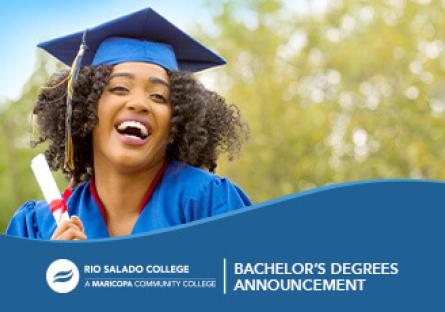 image of a female college student in cap and gown holding a rolled diploma