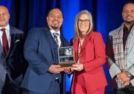 photo of Cordero Holmes with Governor Katie Hobbs holding the MLK Living the Dream award.