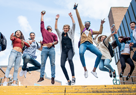students jumping with text: We're celebrating community college month