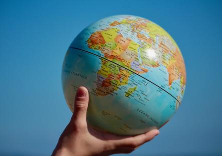 Hand holding up a globe