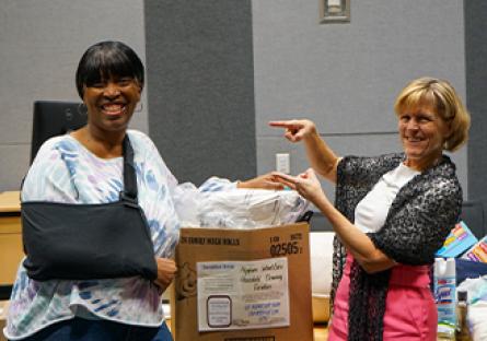 President Smith with Tara Hayman at the packing event