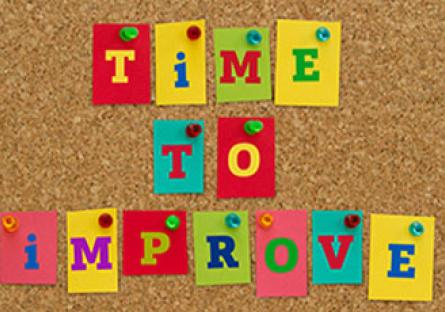 Colored tiles spelling TIME TO IMPROVE