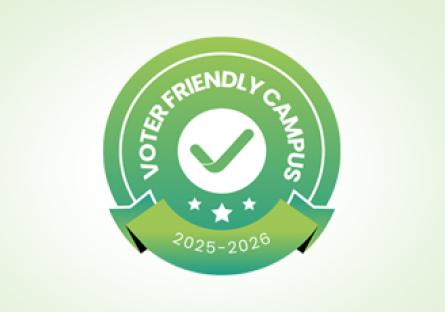 Green and white badge with a checkmark in the center, surrounded by the words "Voter Friendly Campus." Below the checkmark are three stars, and a ribbon at the bottom displays the years "2025–2026." The design has a circular, layered look with a gradient background.