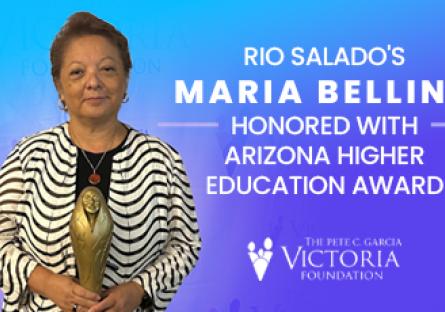 A woman stands holding a golden award statue against a blue backdrop. Text on the right reads: “Rio Salado’s Maria Bellino honored with Arizona Higher Education Award.” Below is the logo for The Pete C. Garcia Victoria Foundation.