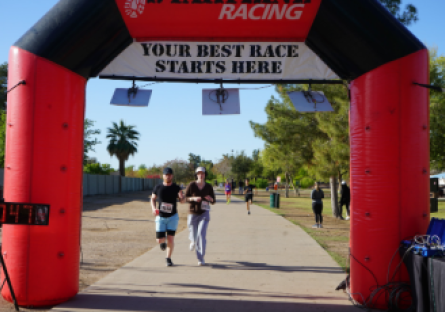 Last year's Dash with Rio at Kiwanis Park (runners running to archway)