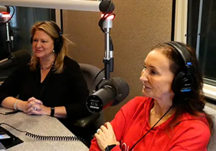 Robin Arredondo-Savage, president and CEO of the Tempe Chamber of Commerce, and Lisa Hausz, program manager in the City of Tempe’s economic development division, sit in a recording studio wearing headphones and speaking into microphones during Rio Salado College’s Wave Makers podcast.