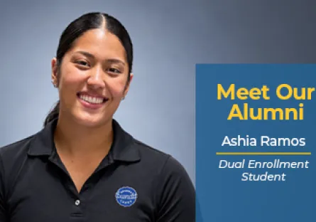 A promo graphic with a medium blue vertical block on the right overlaying a light gray studio background. On the left, Ashia Ramos smiles directly at the camera, wearing a black polo shirt with a round Nothing Bundt Cakes logo on the left chest. Her dark hair is styled back in a low pony. On the blue block, bold yellow text reads "Meet Our Alumni" above white text that reads "Ashia Ramos" underlined in yellow, followed by italicized text that reads "Dual Enrollment Student."