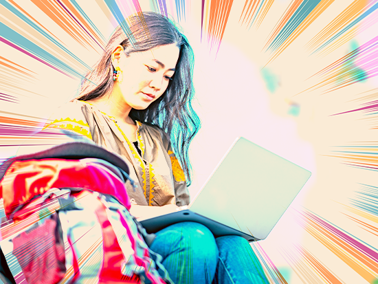Young female student looking at laptop