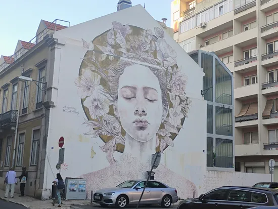 mural of female on a brick wall