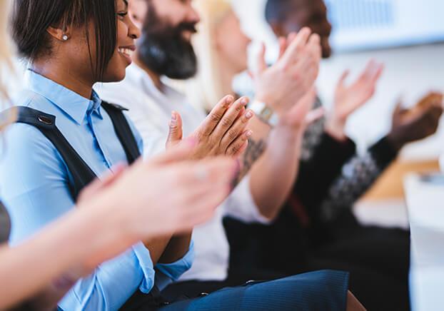 Group of people clapping hands