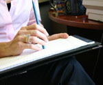 woman writing on notepad
